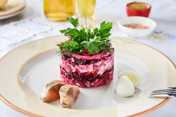 Shuba salad layered, bright tabletop, closeup plating with rustic herbs garnish