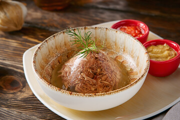 Kholodets with mustard and adjika, rustic lighting, overhead composition