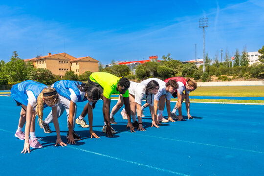 Athletes preparing for race on blue track
