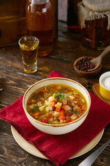 Minestrone soup with diced vegetables, bright rustic lighting, overhead composition