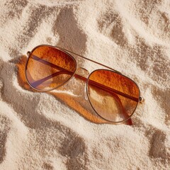 Fototapeta na wymiar Aviator sunglasses on sand