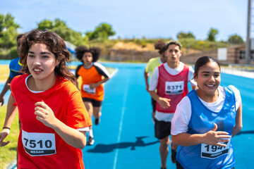 High school athletes running on track during competition