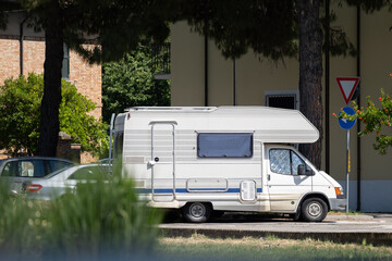 Parked Motorhome in Residential Area with Trees