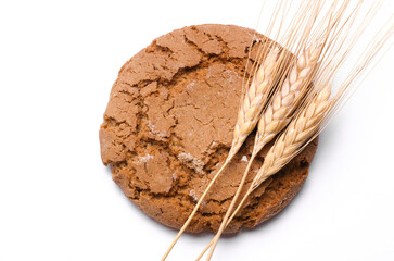 Oatmeal cookies with wheat ears on white background