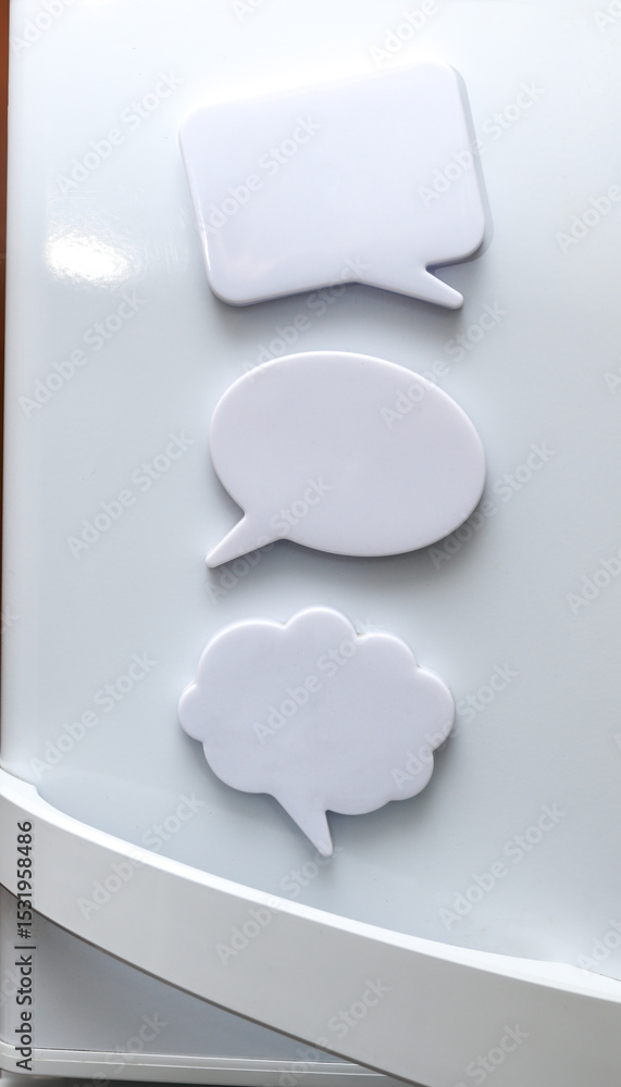 Poster white magnets in the form of a dialog clouds for notes and reminders on the refrigerator door