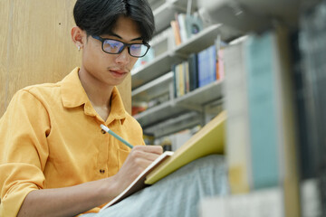 Student Of University Choosing Book and Reading Book In Library.