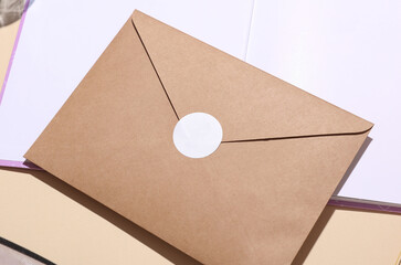 Open notebook or diary and envelope on beige background.