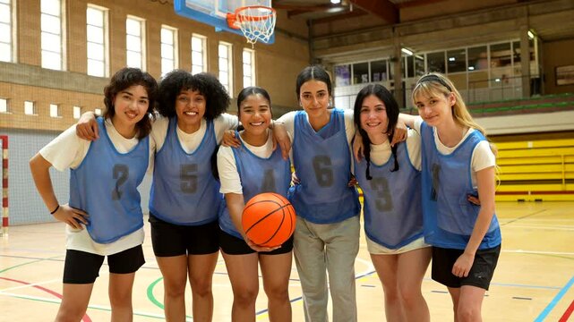 Female basketball team posing for photos