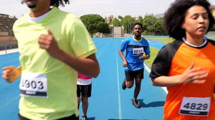 Athletes running on blue track in split screen montage - Powered by Adobe