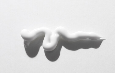 Shape and texture of cream squeezed from a tube on a white background