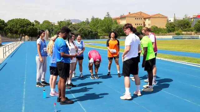 Young athletes preparing for relay race on track