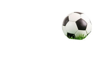 Naklejka premium Classic black and white soccer football ball on fresh green grass patch isolated on white background 