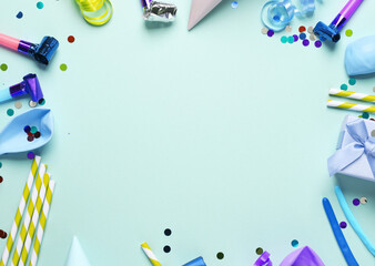 Festive birthday accessories with copy space in the middle on a blue background. Copy space