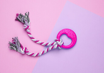 Dog rubber toy with rope on purple background