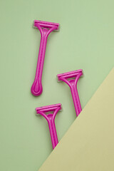 Disposable plastic razors on pastel background, beauty concept. Top view. Creative layout