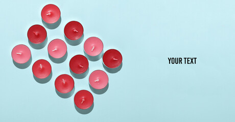 Red Aroma tea candles on blue background. Top view. Copy sapce