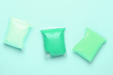 Air plasticine in packs, blue background. Children's creativity. Top view