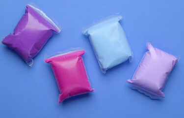 Air plasticine set in packs, purple background. Children's creativity. Top view