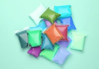 Colored Air plasticine set in packs, mint green background. Children's creativity. Top view