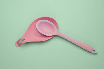 Silicone kitchen utensils on a pastel background. Top view