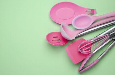 Silicone kitchen utensils on a pastel background. Top view