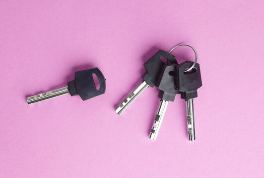 Bunch of keys on a pink background - Powered by Adobe