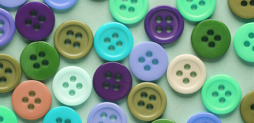 Many colored plastic buttons close-up