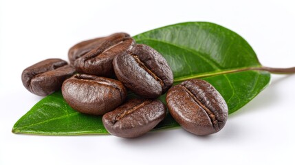 coffee beans with a green leaf - isolated on white background