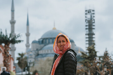 Tourist smiling in front of the blue mosque in istanbul