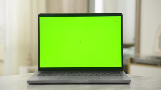 Laptop with Green Screen on Table in Dolly Zoom