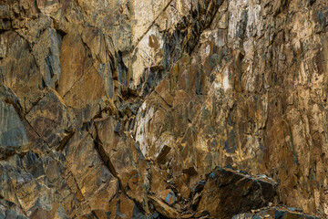 Rugged rock formation in mountainous outdoor setting - full-frame background and texture