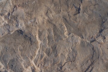 Texture of seaside stones in daylight. Natural stone background for design