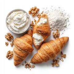 Croissants, cream cheese, walnuts, and flour arranged on a white background