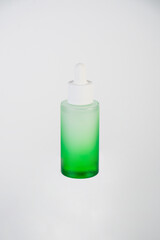 Green glass cosmetic bottle, Skin care or sunscreen cosmetic on white background.