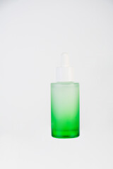 Green glass cosmetic bottle, Skin care or sunscreen cosmetic on white background.