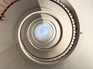 Fototapeta premium Spiral staircase interior with architectural symmetry and light