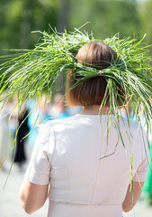 A woman wearing a grass headband