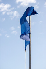 A blue flag is hanging from a pole