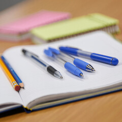 notebooks and pens on the table