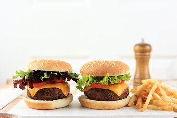Two Homemade Burger with French Fries on White Wooden Table