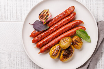 Grilled sausages served with roasted baby potatoes