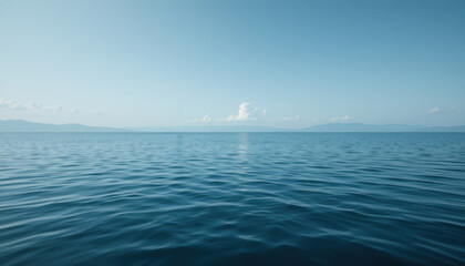 Obraz premium Serene Blue Ocean View with Gentle Waves under Clear Sky and Soft Clouds on the Horizon