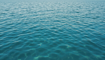 Obraz premium Calm Blue Ocean Water Surface with Gentle Ripples Under Clear Sky Ideal for Nature and Tranquility Themes in Photography and Artwork