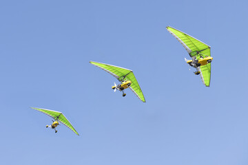 3 paramotors following each other in flight