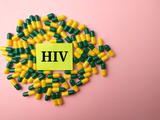 Sticky note and medicine pill with the word HIV on a pink background