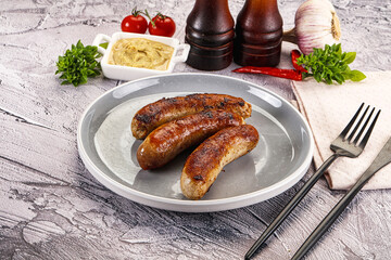 Delicous natural roasted sausages in the plate