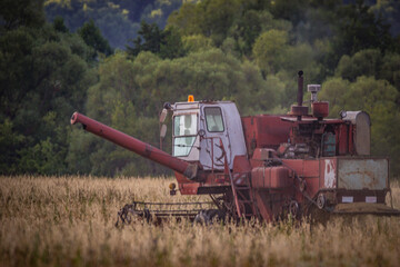 A Soviet combine harvester is working in the field