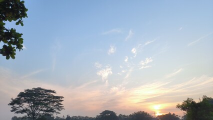 Golden Morning Light Over Lush Landscape: A serene morning scene unfolds with the sun casting a...