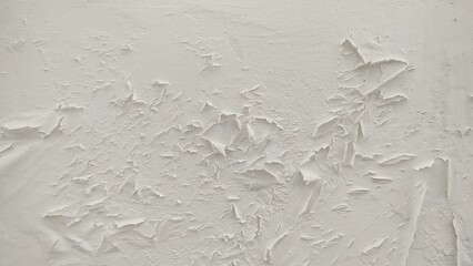peeling, cracked paint and flaking plaster. The texture is rough and aged, revealing layers of...
