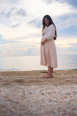 Young pregnant woman relaxing at the sea beach
